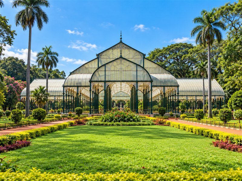 Lalbagh Botanical Garden glasshouse surrounded by lawns and palms